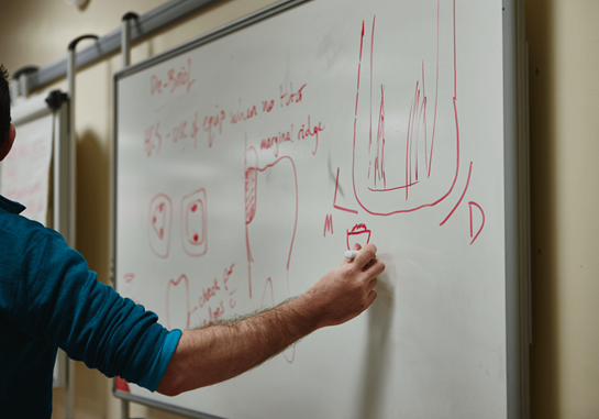 Person writing on a whiteboard